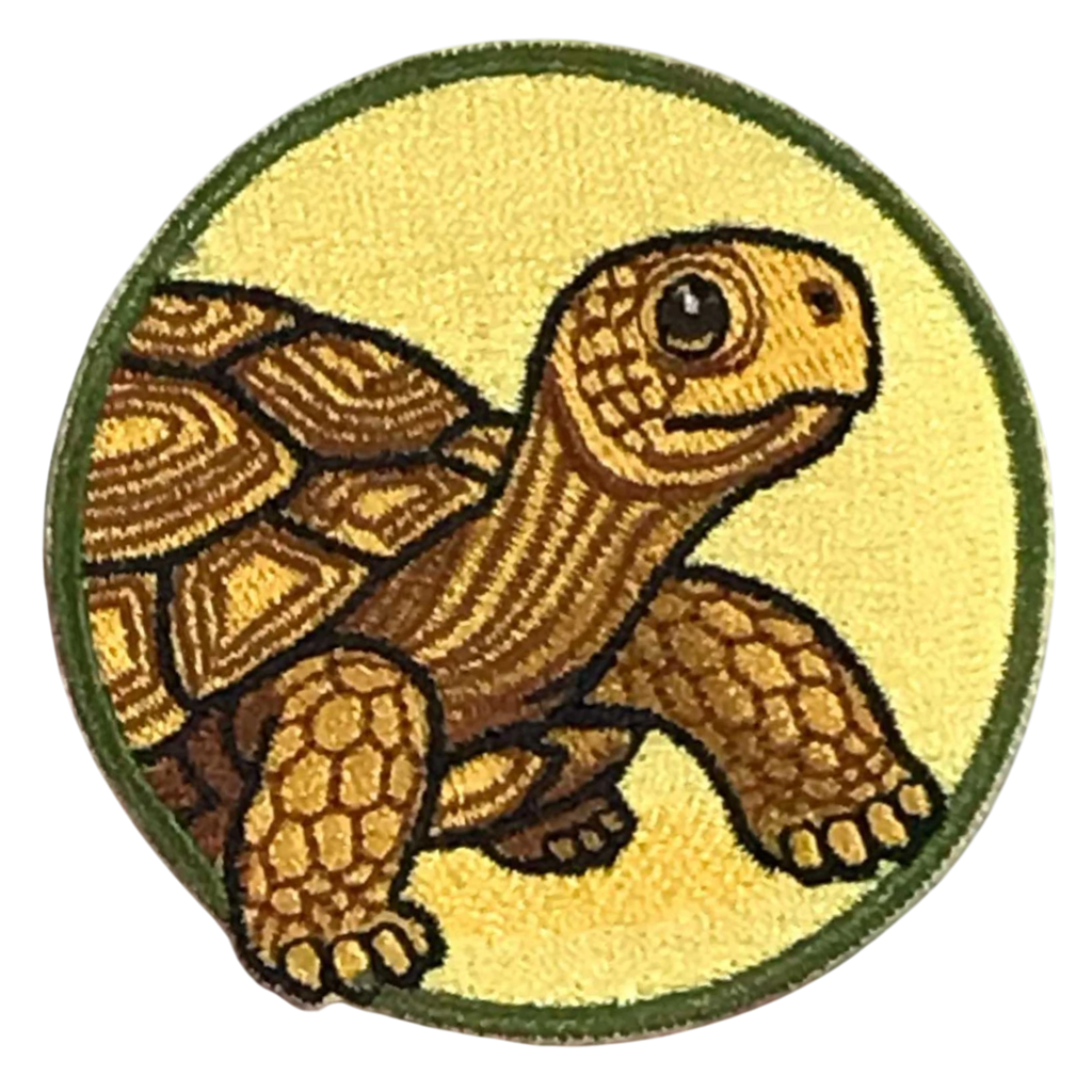 Embroidered patch of a turtle on a yellow background