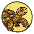 Embroidered patch of a turtle on a yellow background