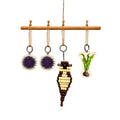 Set of hanging Sea Otter ornaments on a wooden rod with a white background